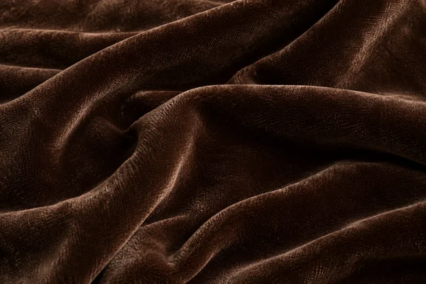 Deep chocolate velvet folds showing dense pile and softly shifting light.